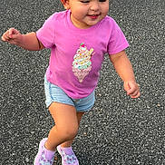 Nathalie is registered to the contest to win money with this photo: toddler, child, running, pink_tshirt, denim_shorts, sneakers, outdoor, asphalt, happy, joyful, casual_clothing, young_child, playful, smiling, shorts, active, person, summer, daylight, cute