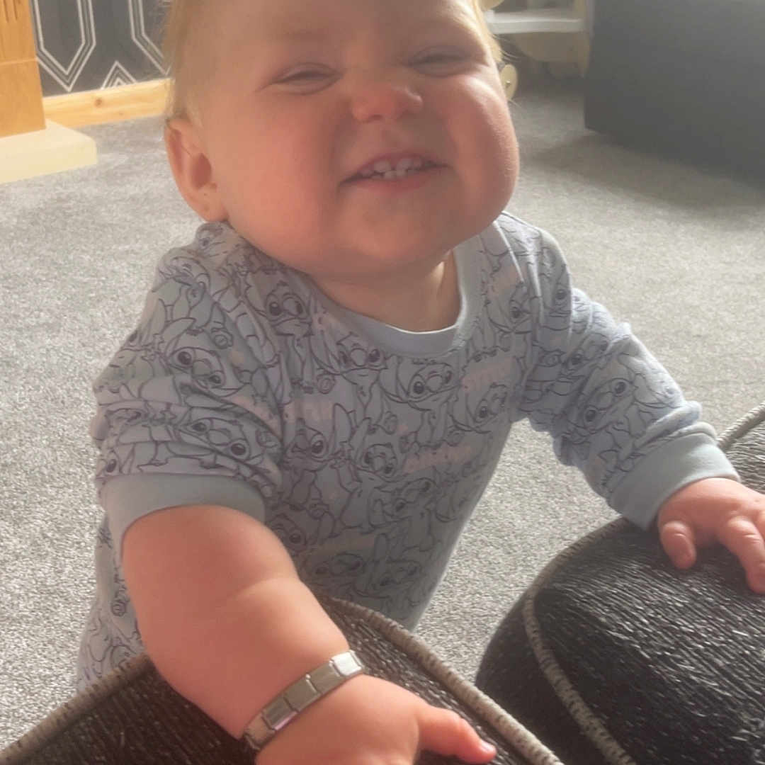 Theo George joined the competition — help win amazing prizes! accessories, architecture, baby, bodypart, bracelet, building, clothing, couch, face, finger, furniture, hand, head, indoors, jewelry, livingroom, pants, person, photography, portrait