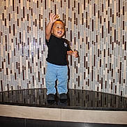 Dexter joined the competition — help win amazing prizes! architecture, black_shirt, child, full_body, geometric, happy, indoor, jeans, laughing, lobby, pattern, portrait, reflection, shiny_floor, shoes, smiling, standing, tile_wall, toddler, waving