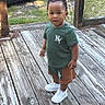 Dexter is registered to the contest to win money with this photo: boy, car, child, clothing, curious, deck, face, green_shirt, lattice, outdoor, parked_car, photography, plant, portrait, shorts, sneakers, standing, sunlight, toddler, wooden_floor