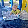 Liam joined the competition — help win amazing prizes! baby, blanket, blue, blue_platform, child, crawling, daylight, expression, face, happy, infant, outdoor, park, plastic_playground, playground, smiling, sunlight, toy, yellow, yellow_clothing