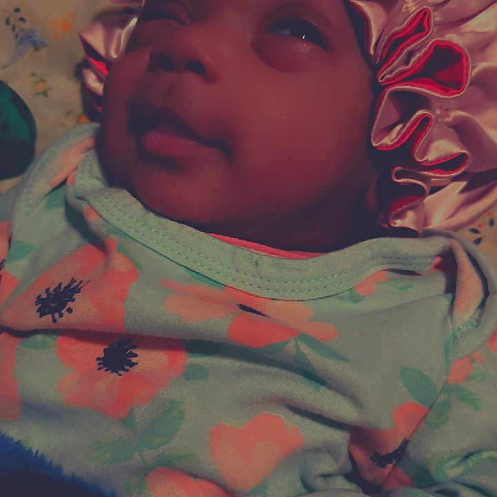 Xamira joined the competition — help win amazing prizes! baby, child, infant, bonnet, flower_pattern, clothing, sleepy, face, portrait, lying_down, blanket, cozy, cute, indoors, soft_light, person, fabric, headwear, smile, skin