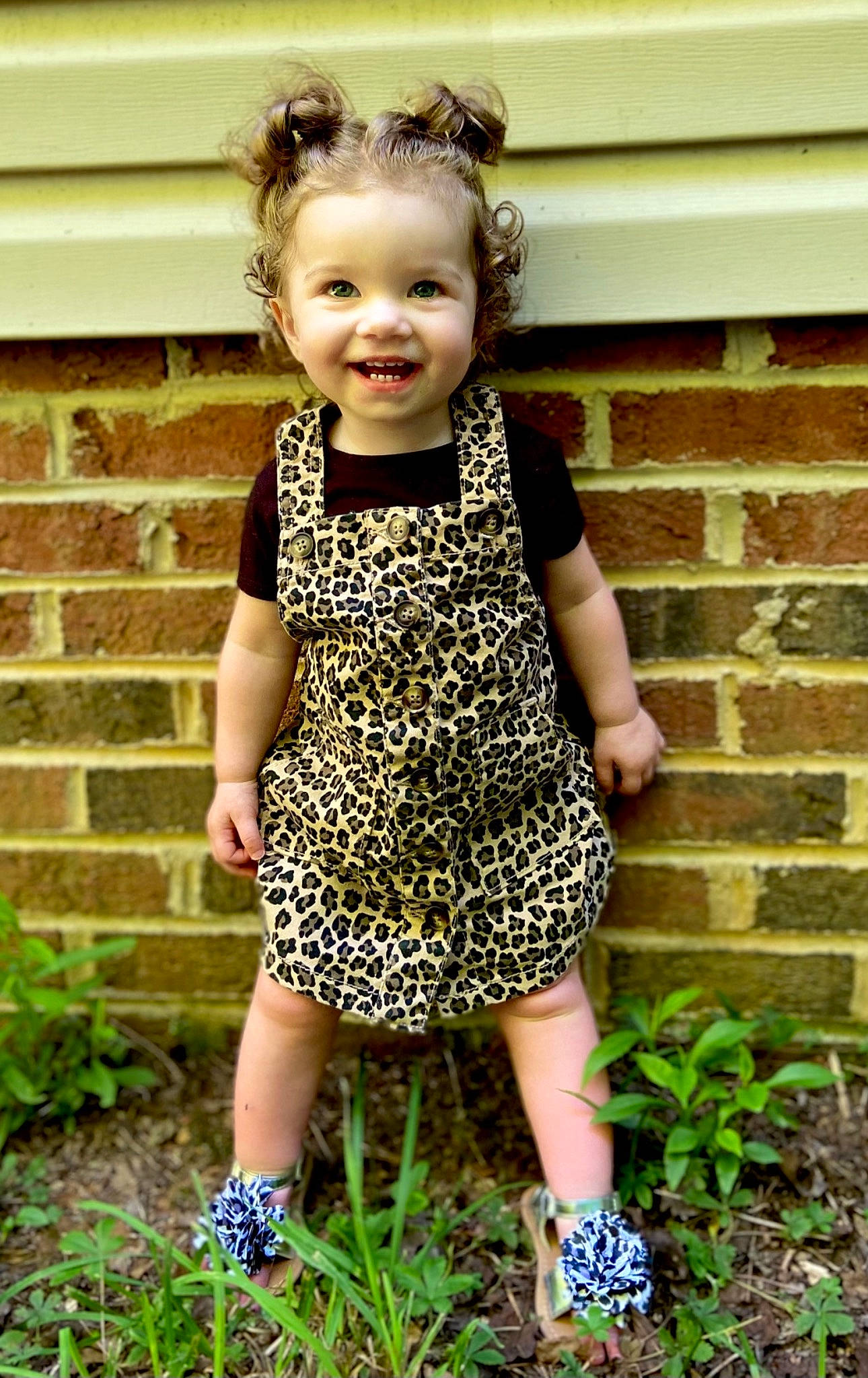 Rylie is registered to the contest to win money with this photo: baby_toddler_clothing, brown_hair, child, day_dress, dress, fashion_accessory, fun, garden, grass, hair, happy, joy, neck, one_piece_garment, pattern, people_in_nature, person, plant, sleeve, smile