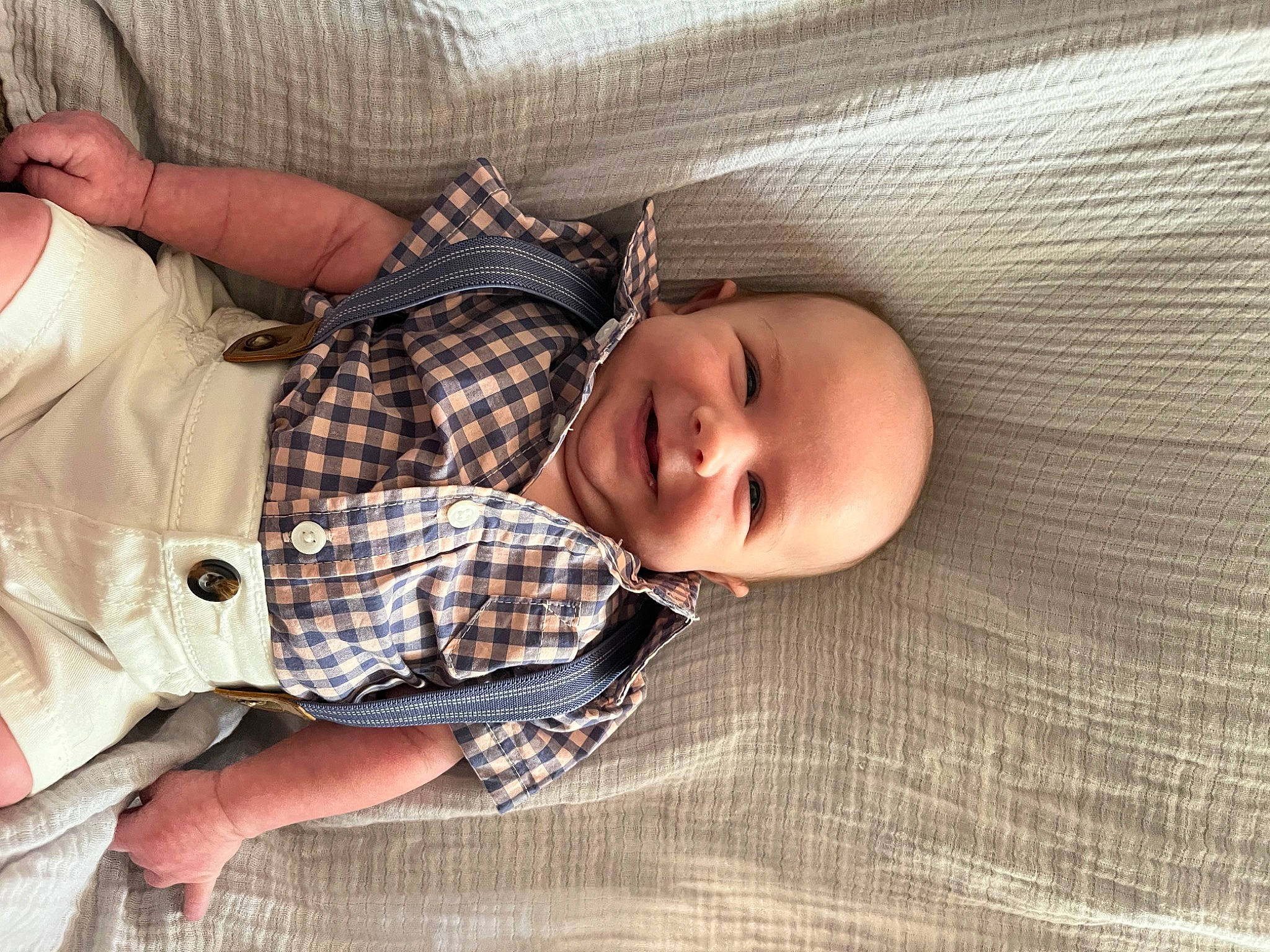 Lane is registered to the contest to win money with this photo: baby, baby_products, baby_toddler_clothing, child, collar, comfort, dress_shirt, happy, human_body, joy, linens, pattern, person, plaid, skin, sleep, sleeve, smile, tartan, thumb