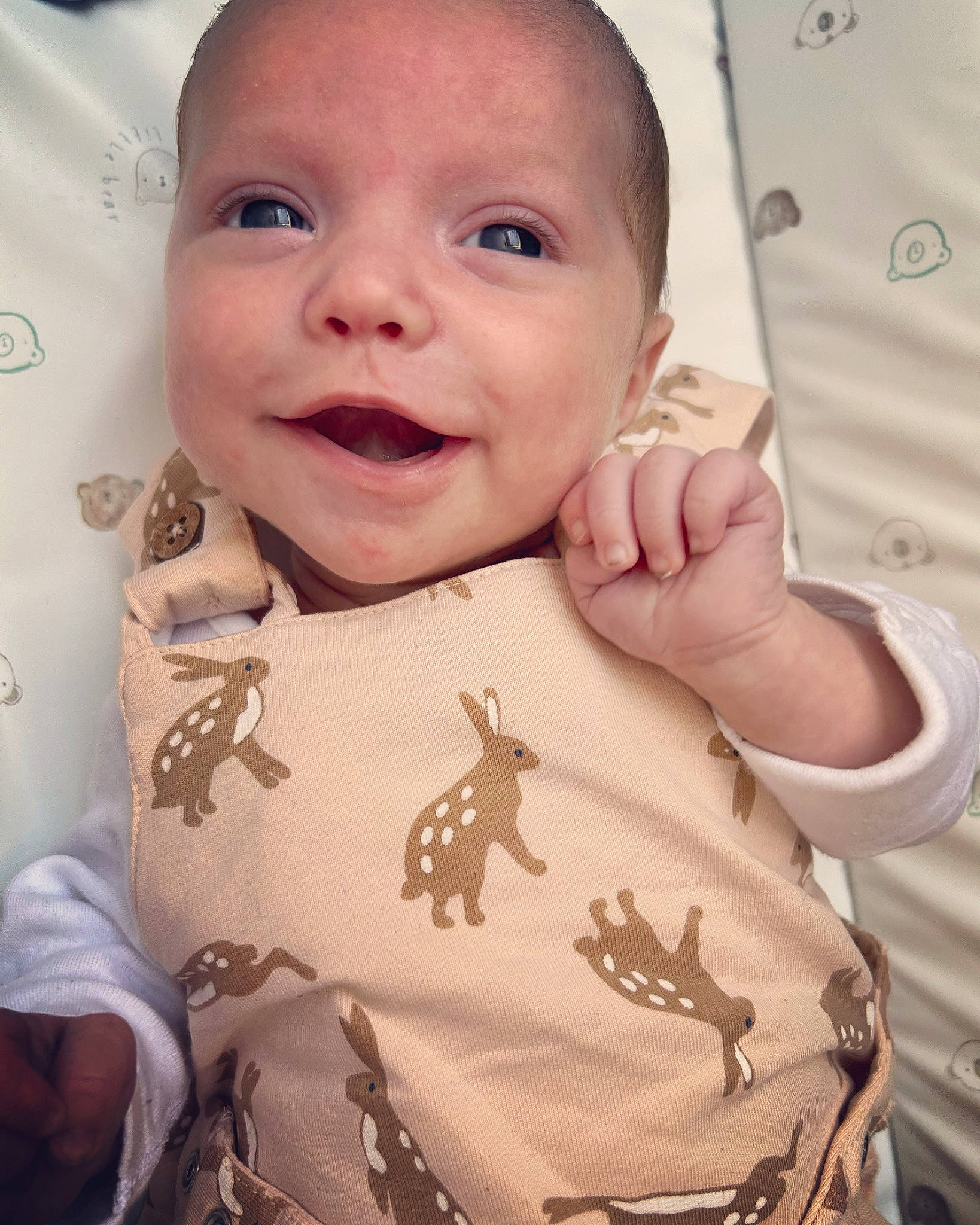 Elijah is registered to the contest to win money with this photo: arm, baby_toddler_clothing, cheek, ear, eyelash, finger, gesture, happy, human_body, lip, mouth, neck, nose, organ, person, pink, skin, sleeve, smile, textile