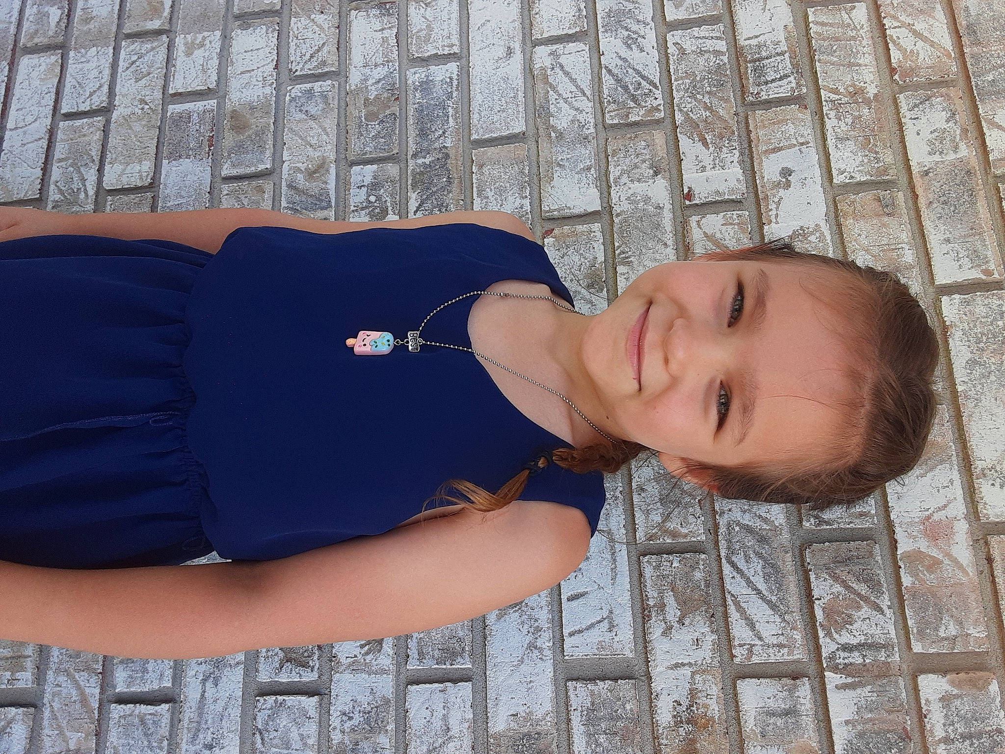 Zendaya is registered to the contest to win money with this photo: child, comfort, elbow, electric_blue, flooring, fun, grass, hat, human_leg, joint, joy, pattern, person, sitting, sleeve, smile, t_shirt, thigh, toddler, tree