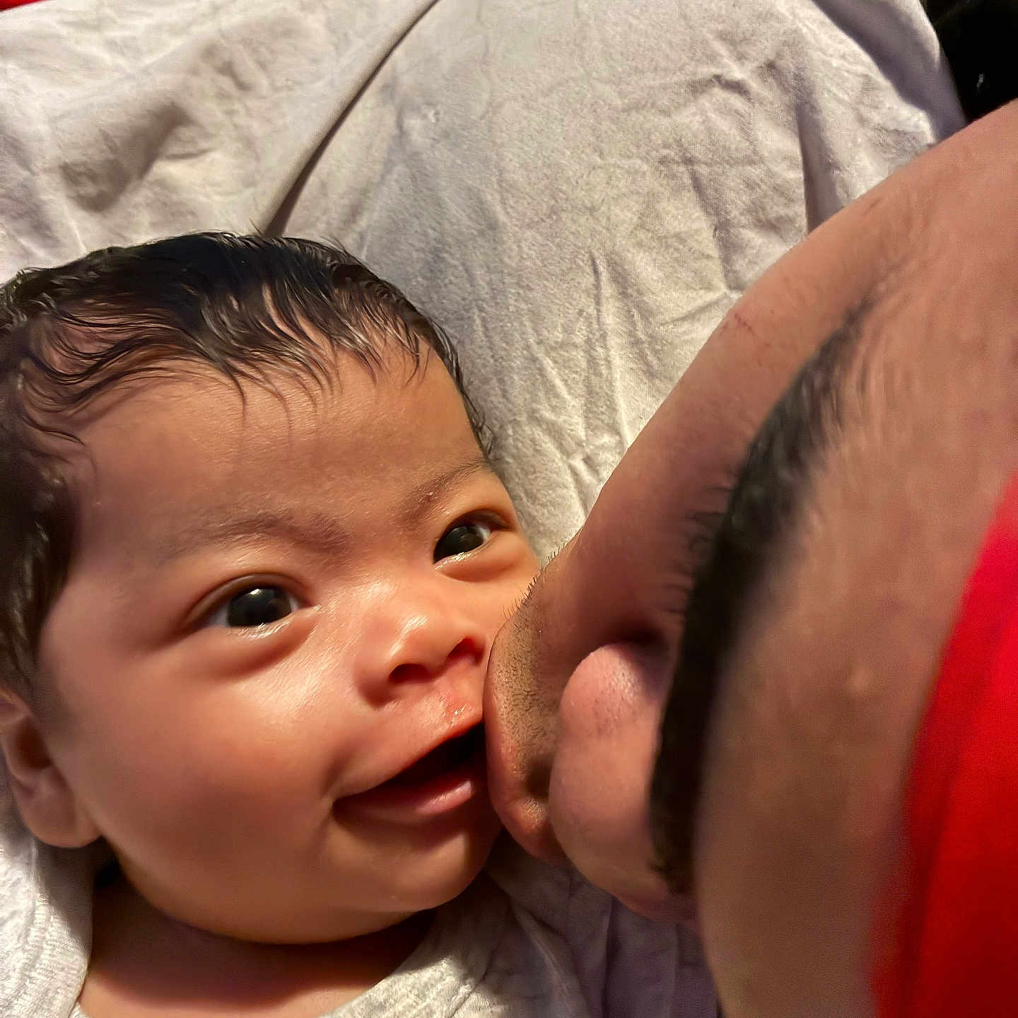 Jhnae joined the competition — help win amazing prizes! adult, affection, baby, blanket, closeup, clothing, cuddle, expression, eyebrows, eyes, face, hair, infant, kiss, love, person, red, skin, smiling, white