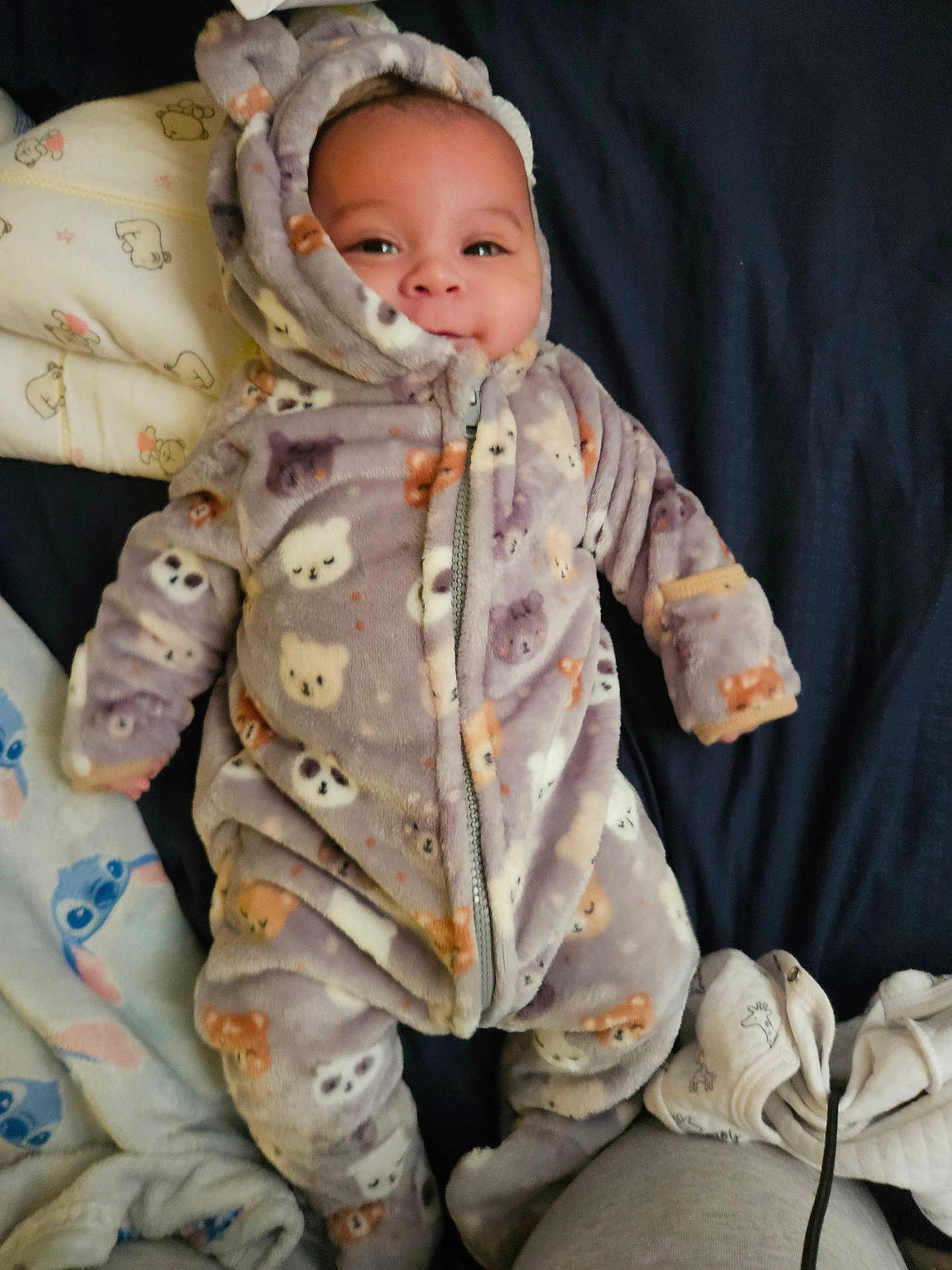 Armani joined the competition — help win amazing prizes! baby, infant, child, onesie, hoodie, pajamas, blanket, bed, smile, face, eyes, cute, cozy, zipper, pattern, plush_pattern, fabric, lying_down, sleeve, footie