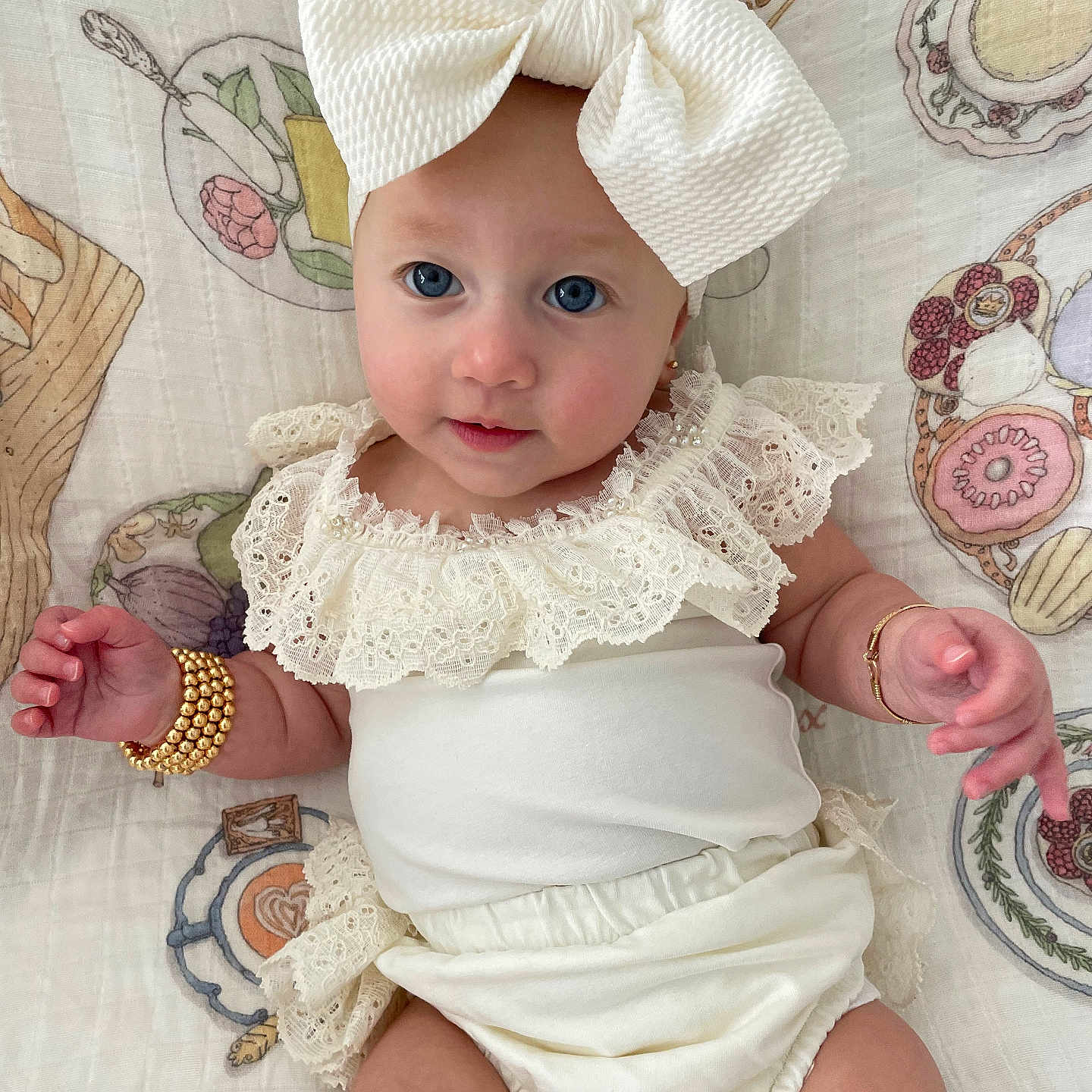Belle is registered to the contest to win money with this photo: accessories, baby, bodypart, bonnet, bracelet, cap, clothing, diaper, dress, face, finger, hand, hat, head, jewelry, person, photography, portrait, sitting, sunhat