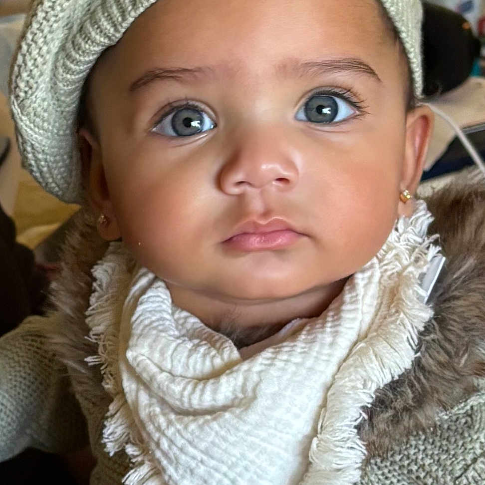Navi joined the competition — help win amazing prizes! baby, beanie, bonnet, cap, clothing, coat, couch, face, frown, furniture, hat, head, knitwear, newborn, person, photography, portrait, sad, scarf, sweater