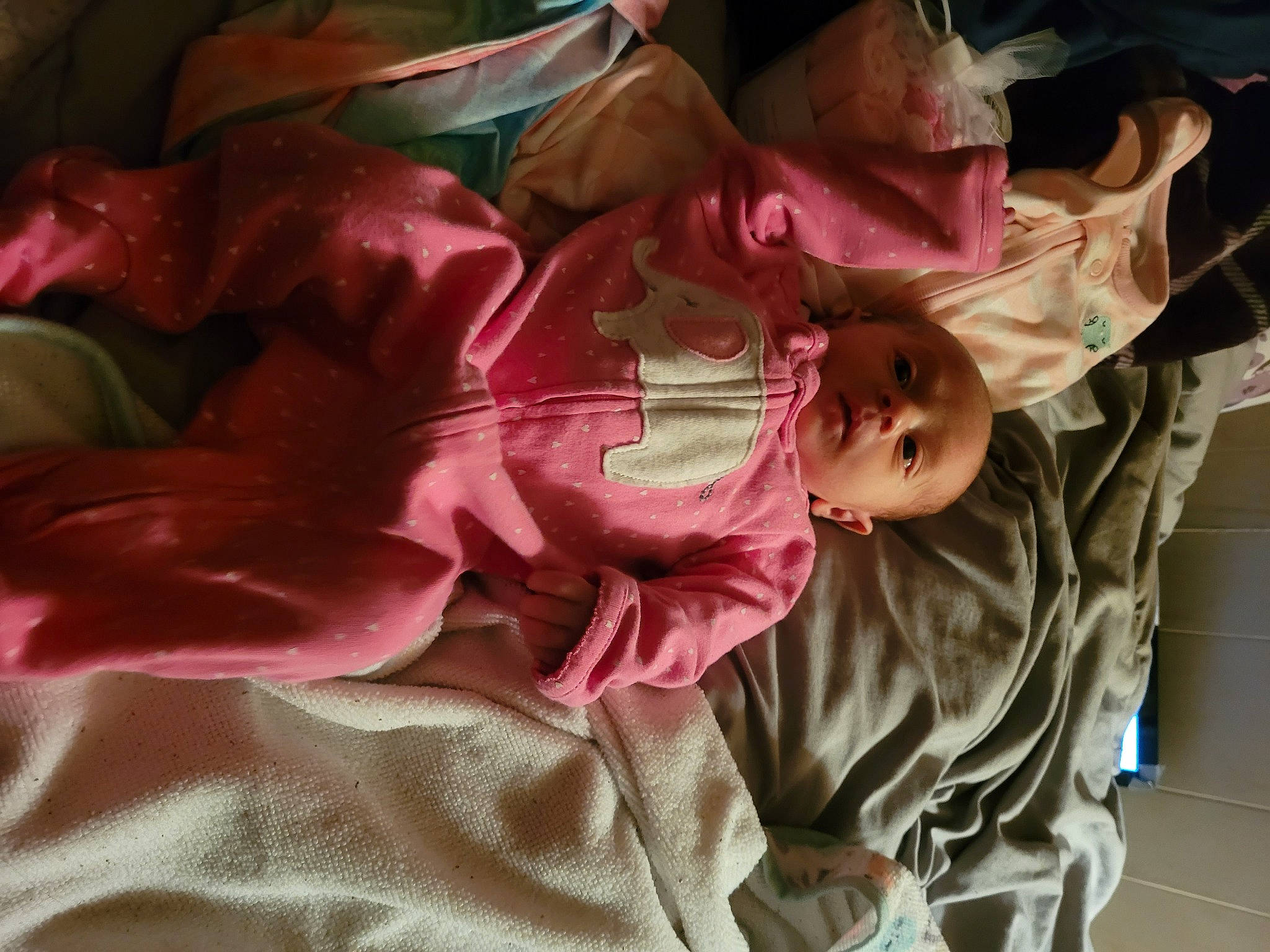 Kamilah is registered to the contest to win money with this photo: baby, baby_products, baby_toddler_clothing, cheek, child, comfort, fun, human_body, linens, magenta, mouth, person, petal, pink, plant, room, skin, sleeve, textile, toddler