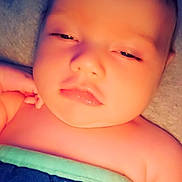 Travise is registered to the contest to win money with this photo: baby, infant, blanket, sleepy, face, skin, child, closeup, portrait, indoors, soft_light, young, resting, cuteness, comfort, human, expression, peaceful, relaxation, toddler