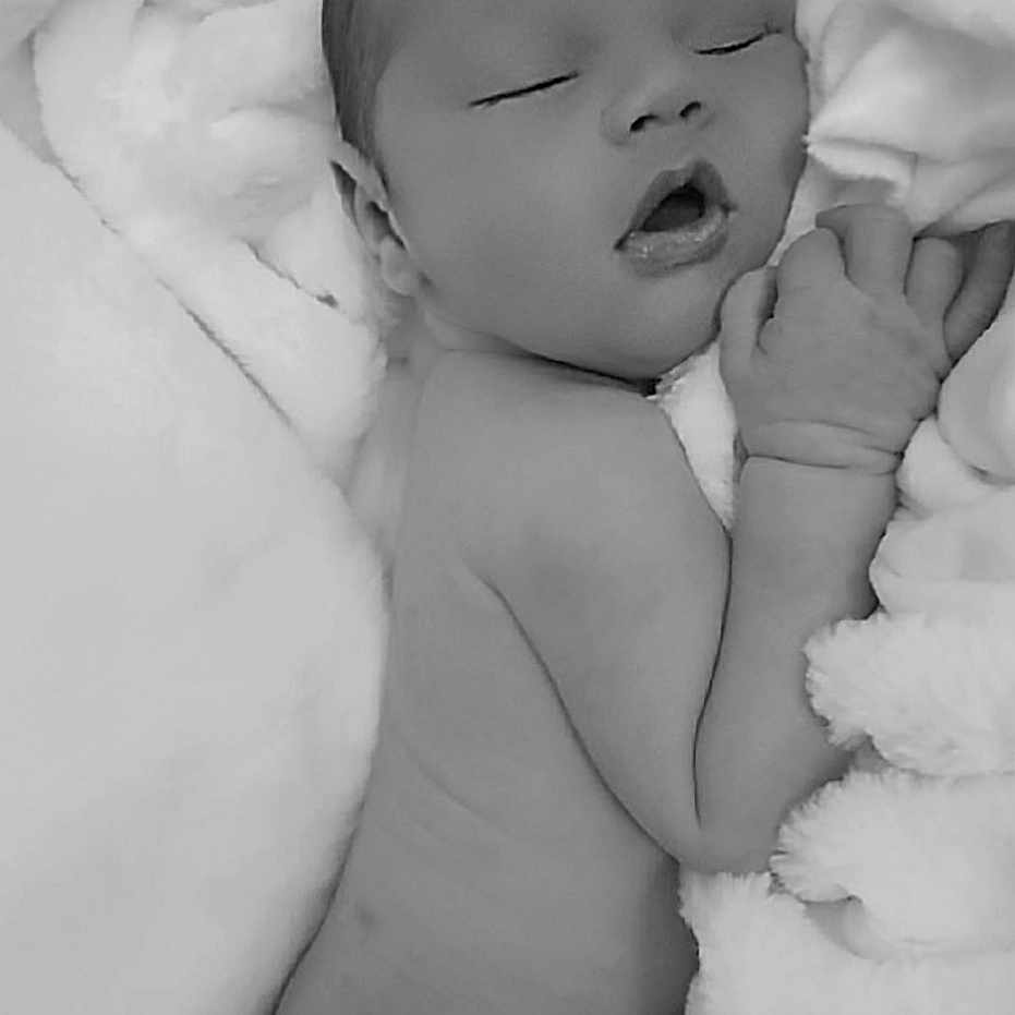 Travise is registered to the contest to win money with this photo: adorable, baby, black_and_white, blanket, child, cozy, cute, face, hand, infant, lying_down, monochrome, newborn, peaceful, portrait, resting, skin, sleeping, soft, toddler