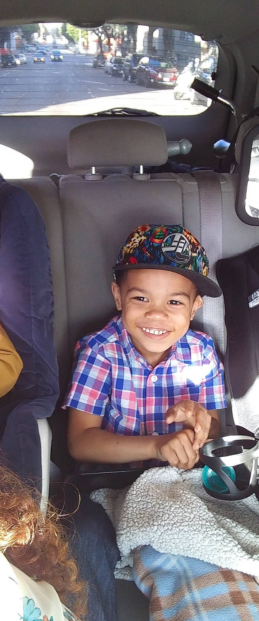 Carlton is registered to the contest to win money with this photo: auto_part, car, car_seat, child, family_car, headwear, joy, person, sitting, toddler, vehicle
