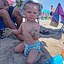 Mathys a rejoint le concours — aidez-le/la à gagner de superbes lots ! beach, blue_sky, child, family, hat, kneeling, outdoor, people, play, relaxation, sand, sandcastle, serious_face, summer, sunny, swim_diaper, toddler, toy, umbrella, vacation