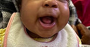 Kahlani joined the competition — help win amazing prizes! baby, smiling, bib, face, child, happy, portrait, infant, clothing, blanket, mouth_open, cute, person, expression, skin, head, indoors, holding, fabric, cozy
