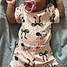 Kahlani joined the competition — help win amazing prizes! baby, pacifier, pink_outfit, mickey_mouse_pattern, bows, lying_down, infant, clothing, soft_surface, cute, child, sleepwear, baby_girl, casual, relaxed, indoors, portrait, small_hands, comfortable, resting