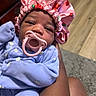 Kahlani is registered to the contest to win money with this photo: baby, infant, pacifier, bonnet, pink, blue_onesie, hand, skin, floor, rug, indoor, cute, newborn, sleepy, child, person, portrait, cozy, soft, clothing
