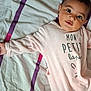 Rose participe au concours pour gagner de l'argent avec cette photo : baby, child, infant, bed, blanket, clothing, face, person, portrait, cute, pink, striped, sleepwear, soft, expression, young, indoor, laying, eyes, young_child