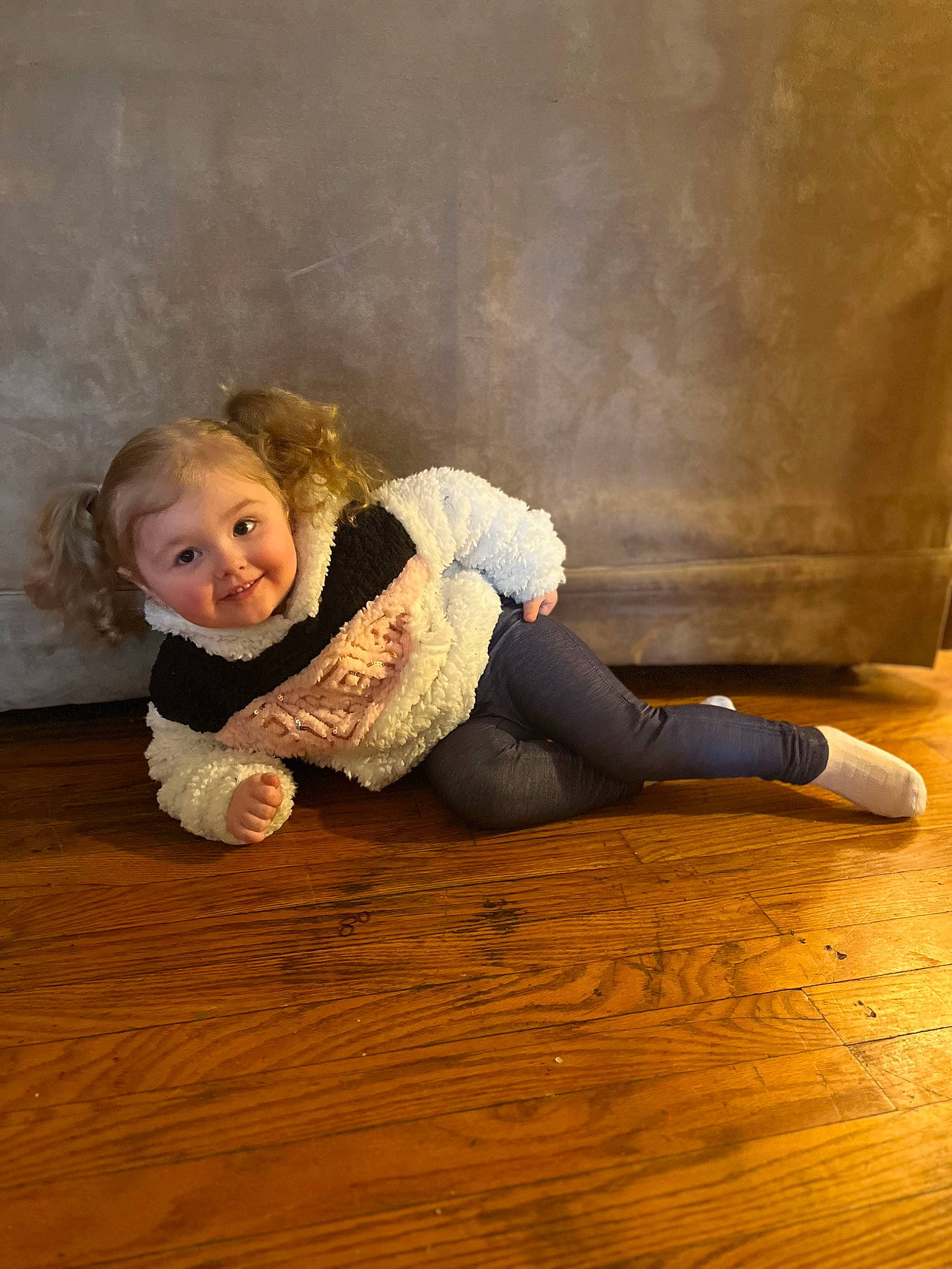 Layla joined the competition — help win amazing prizes! blond, boot, comfort, flash_photography, floor, flooring, foot, fun, happy, hardwood, human_leg, jeans, joy, knee, laminate_flooring, person, smile, sneakers, thigh, toddler