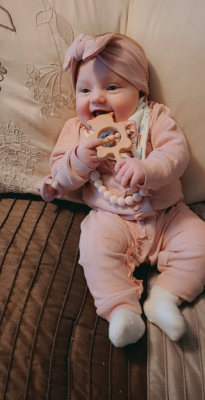 Ava Genevieve is registered to the contest to win money with this photo: baby, baby_toddler_clothing, brown_hair, child, companion_dog, eye, face, fawn, flooring, fur, gesture, happy, outerwear, person, pink, sitting, skin, sleeve, smile, toddler