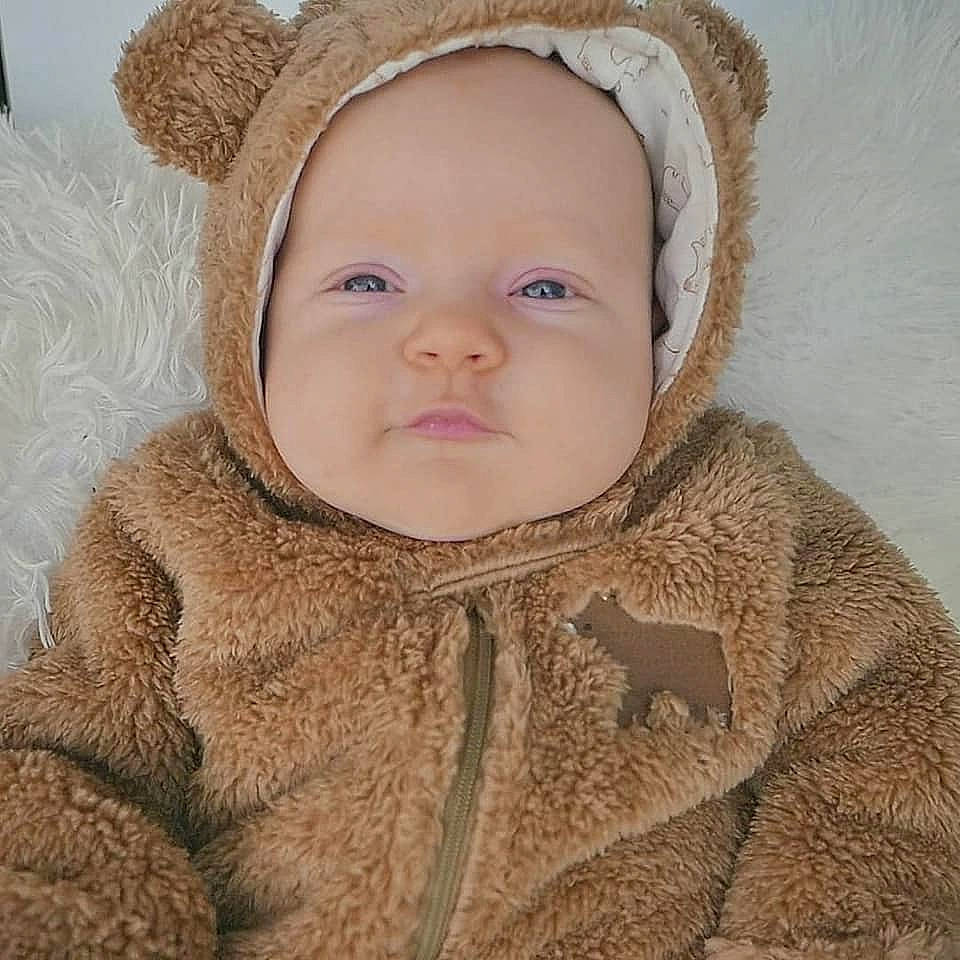 Claire is registered to the contest to win money with this photo: baby, beige, bonnet, cheek, child, ear, eye, face, fawn, fur, fur_clothing, head, headgear, hood, organ, outerwear, person, portrait, skin, toddler