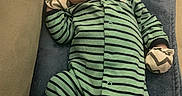Miles is registered to the contest to win money with this photo: baby, newborn, sleeping, onesie, striped_clothing, mittens, blanket, blue_blanket, indoor, infant, cute, peaceful, resting, child, portrait, soft_lighting, cozy, head, face, person