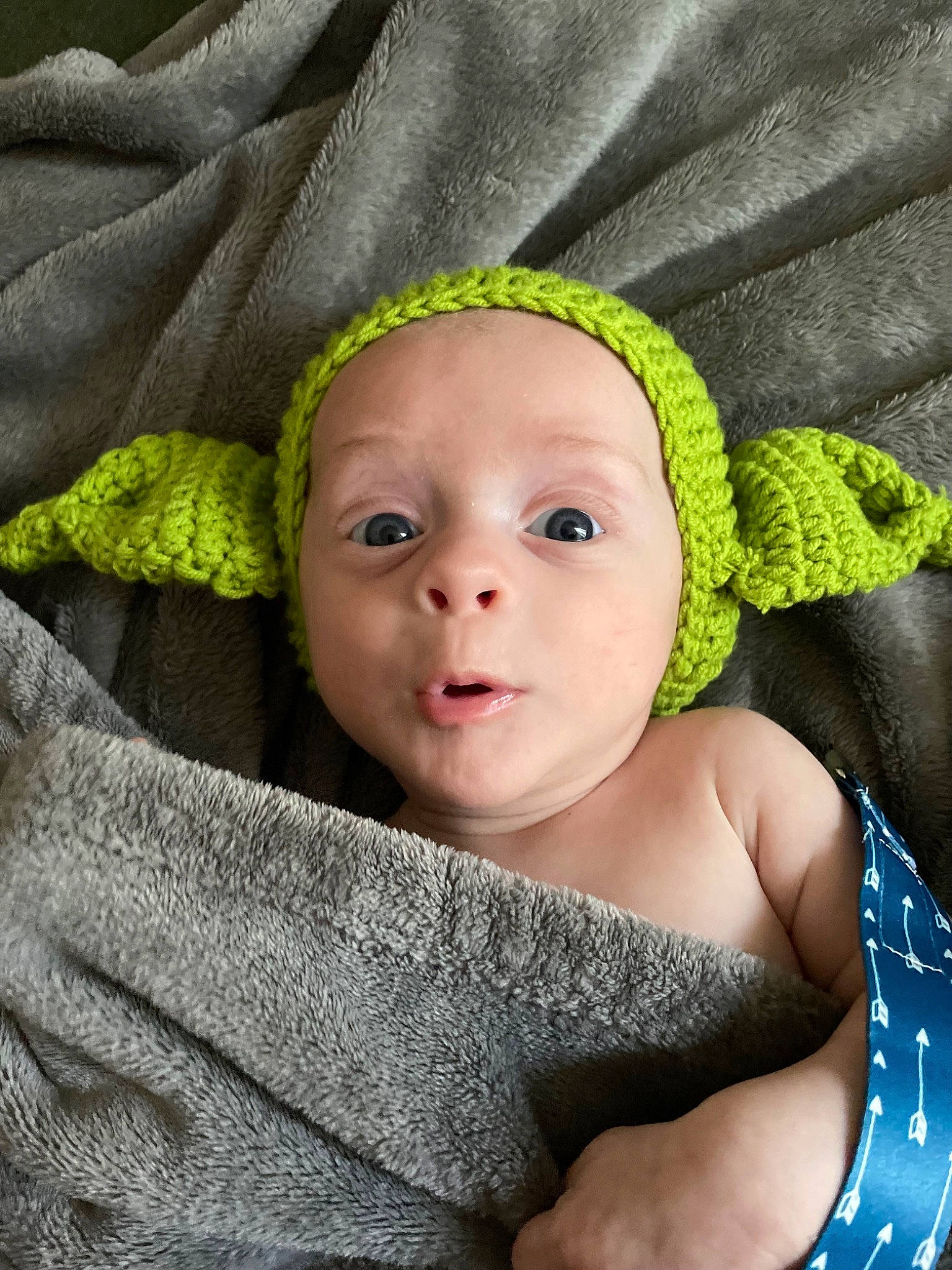 Colton is registered to the contest to win money with this photo: baby, baby_products, baby_toddler_clothing, cheek, child, chin, close_up, comfort, eye, face, fashion_accessory, flash_photography, grass, happy, headgear, headwear, linens, person, portrait_photography, product
