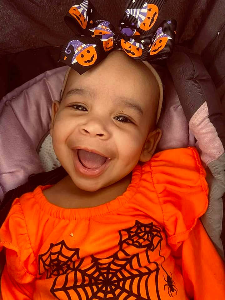 Sophia is registered to the contest to win money with this photo: cheek, child, chin, cool, eye, flash_photography, fun, happy, headgear, human, human_body, joy, mouth, nose, orange, organ, person, pink, sleeve, smile