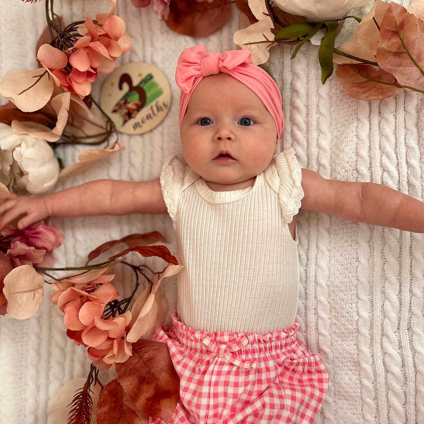 Josie is registered to the contest to win money with this photo: accessories, baby, bonnet, cap, clothing, face, flower, flowerarrangement, flowerbouquet, hat, head, leaf, newborn, person, petal, photography, plant, portrait, rose, shorts