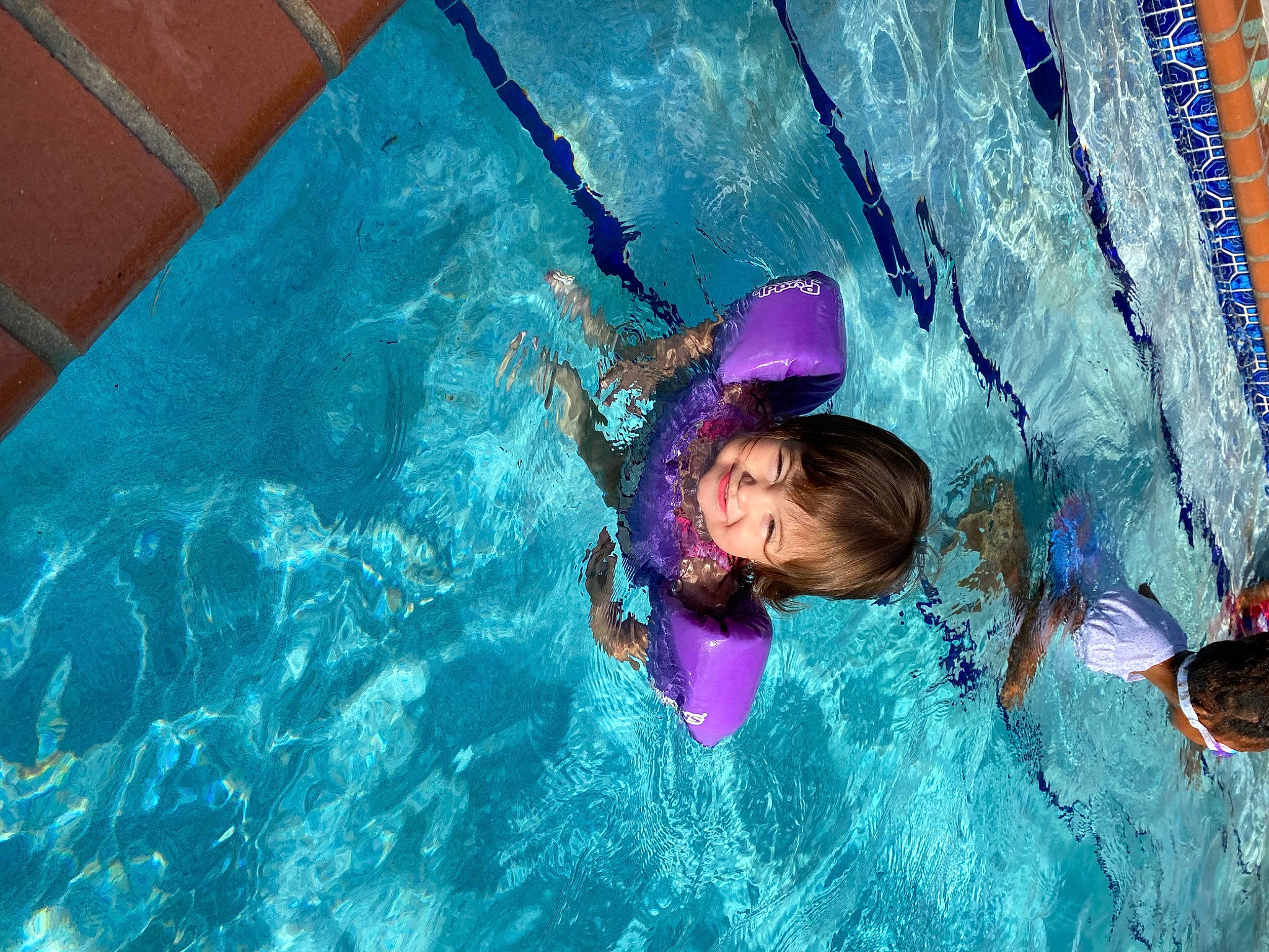 Naia is registered to the contest to win money with this photo: blue, child, fun, joy, leisure, person, play, purple, recreation, swimming, swimming_pool, vacation, water