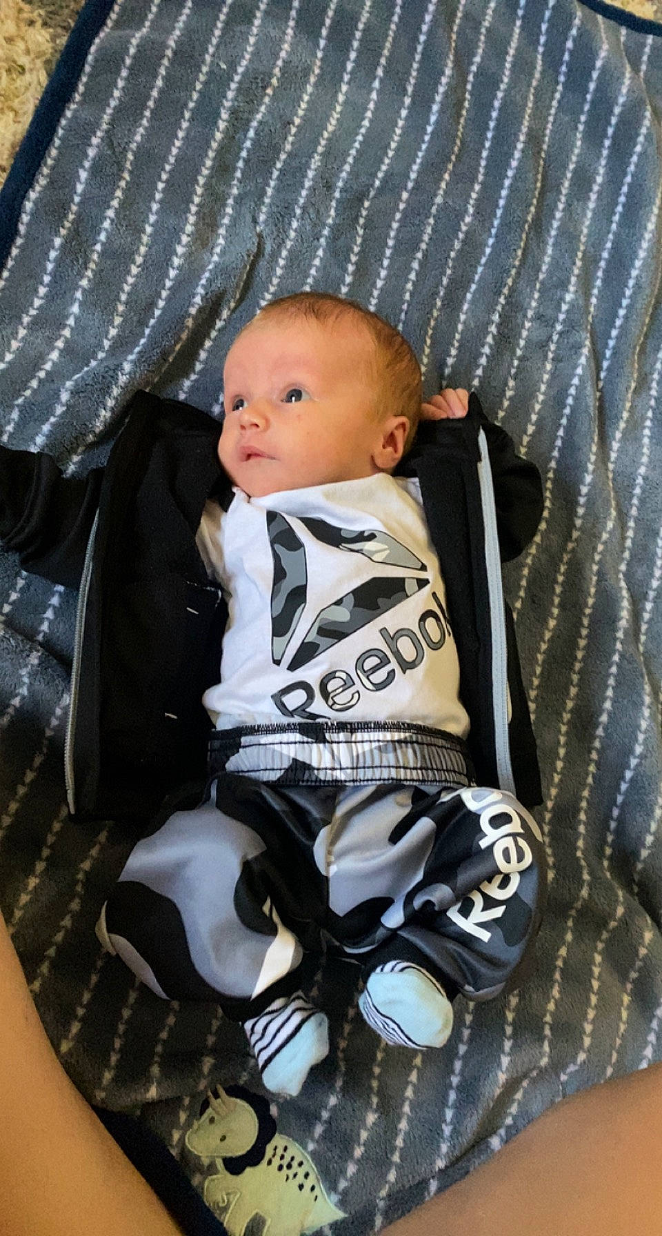 Kyler is registered to the contest to win money with this photo: baby, baby_carriage, baby_products, baby_safety, baby_toddler_clothing, carmine, chair, child, comfort, pattern, person, personal_protective_equipment, product, sitting, sleeve, toddler