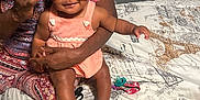 Journee joined the competition — help win amazing prizes! baby, adult, glasses, headband, pink_bow, bed, bedspread, eiffel_tower_print, socks, indoor, person, holding, smiling, cute, child, fabric, patterned_clothing, family, close_up, playful
