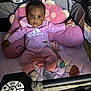 Journee joined the competition — help win amazing prizes! baby, pink_clothing, plush_toy, playpen, pacifier, infant, onesie, soft_toys, child, cute, indoor, face, footwear, toy, blanket, person, sitting, looking, adorable, infancy