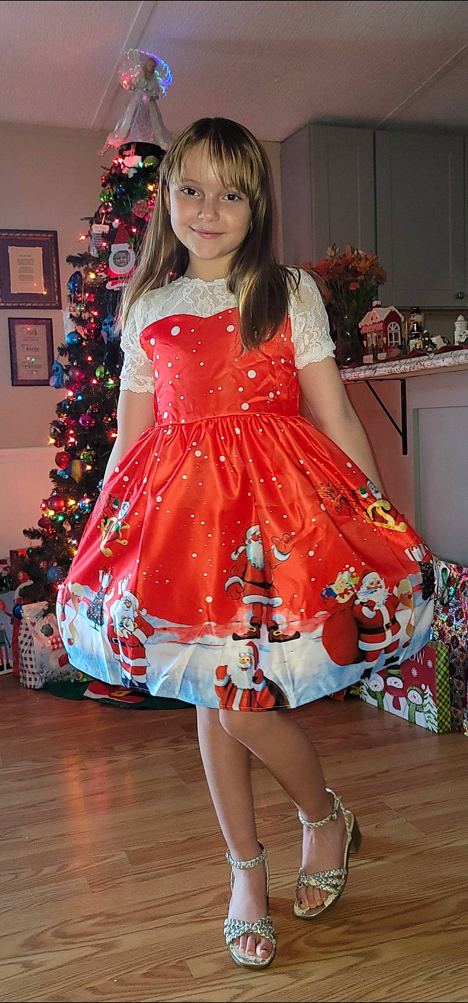 Emily joined the competition — help win amazing prizes! christmas_tree, day_dress, dress, event, fashion_design, flooring, formal_wear, hairstyle, happy, human_leg, joy, leg, long_hair, one_piece_garment, peach, person, sleeve, smile, thigh, tradition