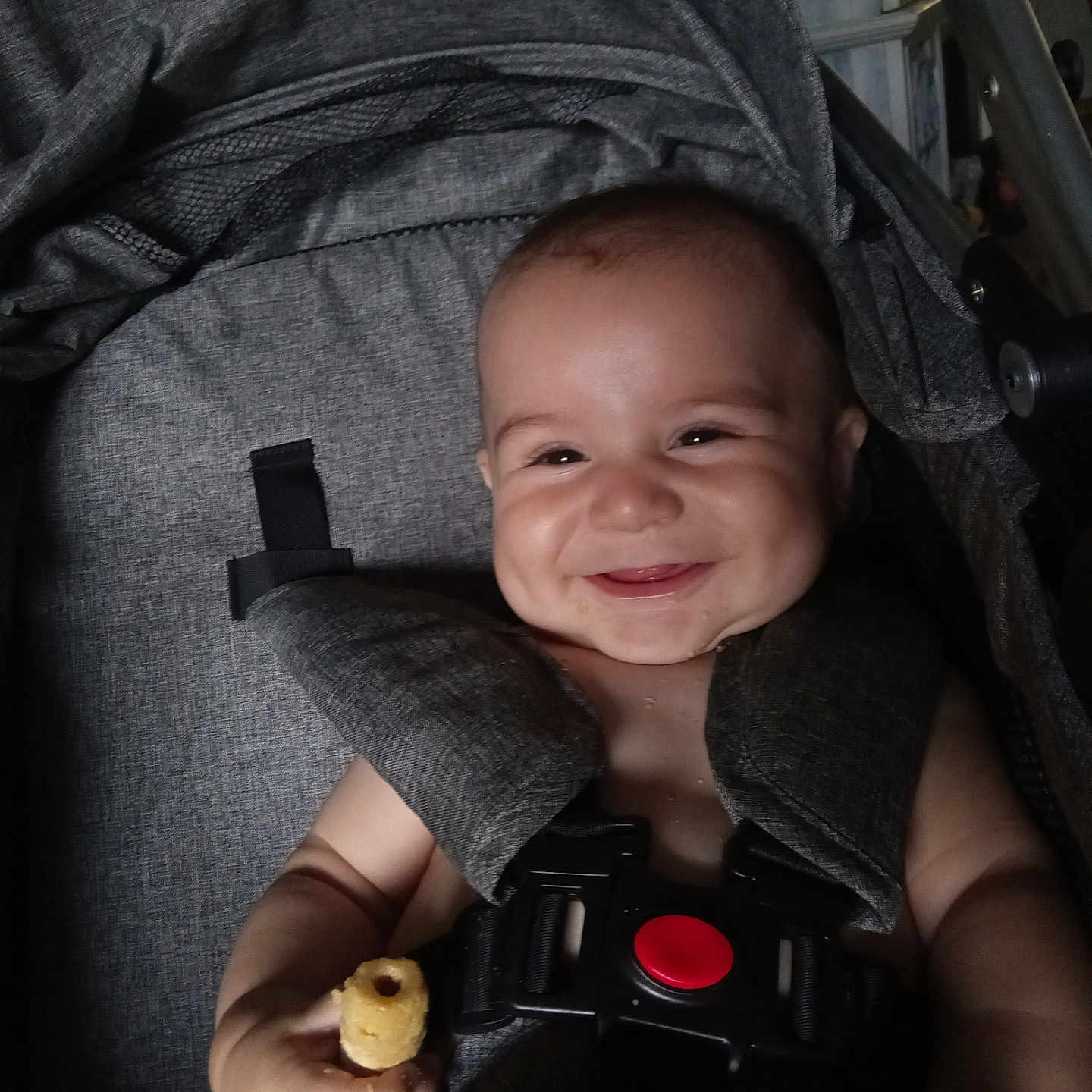 Gabriel is registered to the contest to win money with this photo: baby, bodypart, car, car_interior, carseat, face, finger, furniture, gun, hand, happy, head, person, photography, portrait, smile, stroller, transportation, vehicle, weapon
