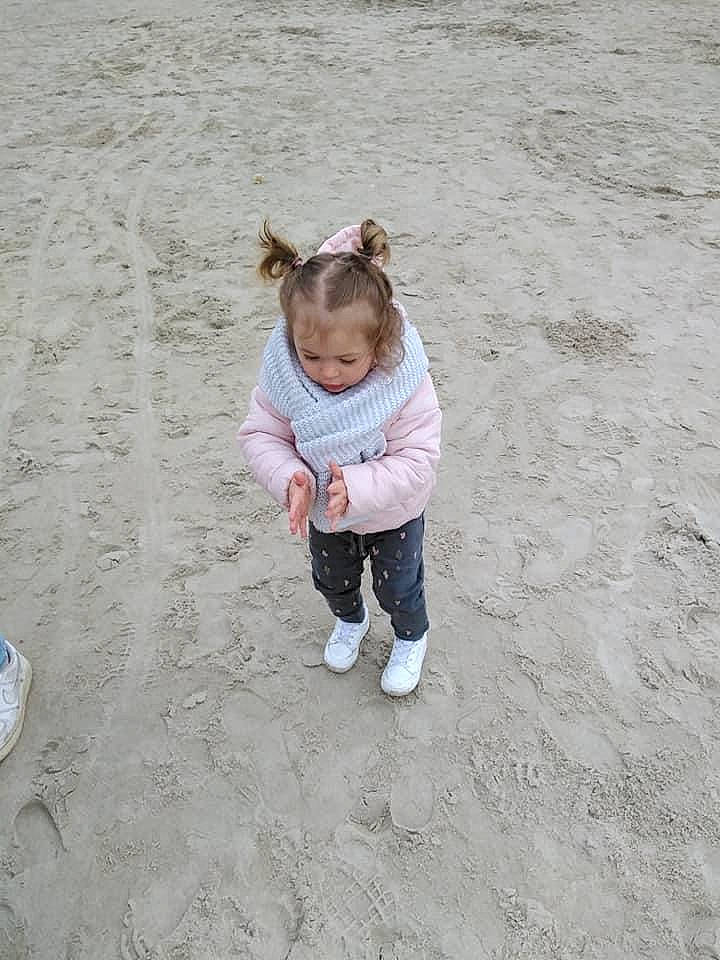 Marissa participe au concours pour gagner de l'argent avec cette photo : asphalt, baby, baby_toddler_clothing, child, coast, fun, grass, happy, jeans, landscape, people_in_nature, person, play, recreation, road_surface, sand, sitting, sleeve, soil, toddler