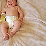 baby, diaper, bottle, smile, blanket, infant, skin, happy, lying_down, child, cute, one_person, indoor, young, chubby, relaxation, comfort, soft_texture, naked_torso, joy