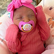 Lydia joined the competition — help win amazing prizes! baby, newborn, pacifier, pink_clothing, headwrap, sleeping, infant, blanket, cushion, cute, indoors, child, soft_toys, resting, peaceful, portrait, closeup, cozy, nursery, person