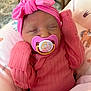 baby, newborn, pacifier, pink_clothing, headwrap, sleeping, infant, blanket, cushion, cute, indoors, child, soft_toys, resting, peaceful, portrait, closeup, cozy, nursery, person