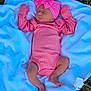 baby, sleeping, pink_clothing, headband, bow, blanket, outdoor, grass, newborn, infant, cute, peaceful, soft_texture, lying_down, child, portrait, toddler, clothing, person, resting