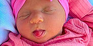 Lydia joined the competition — help win amazing prizes! baby, infant, sleeping, pink, headband, bow, tongue, blanket, clothing, portrait, face, child, cute, soft, resting, newborn, outdoor, closeup, person, peaceful