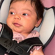 Ashley joined the competition — help win amazing prizes! adorable, awake, baby, buckled, car_seat, child, close_up, eyes, face, hair, harness, indoors, infant, photography, pink_background, pink_clothing, portrait, safe, sitting, transportation