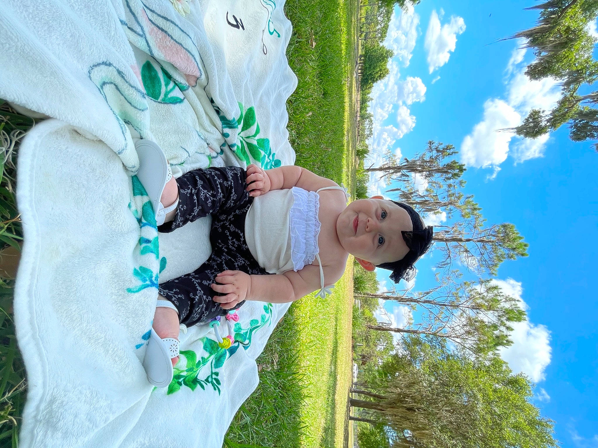 Delilah is registered to the contest to win money with this photo: azure, blue, cloud, daytime, electric_blue, fun, grass, green, happy, hat, leaf, leisure, line, people_in_nature, person, plant, sky, smile, tree, white