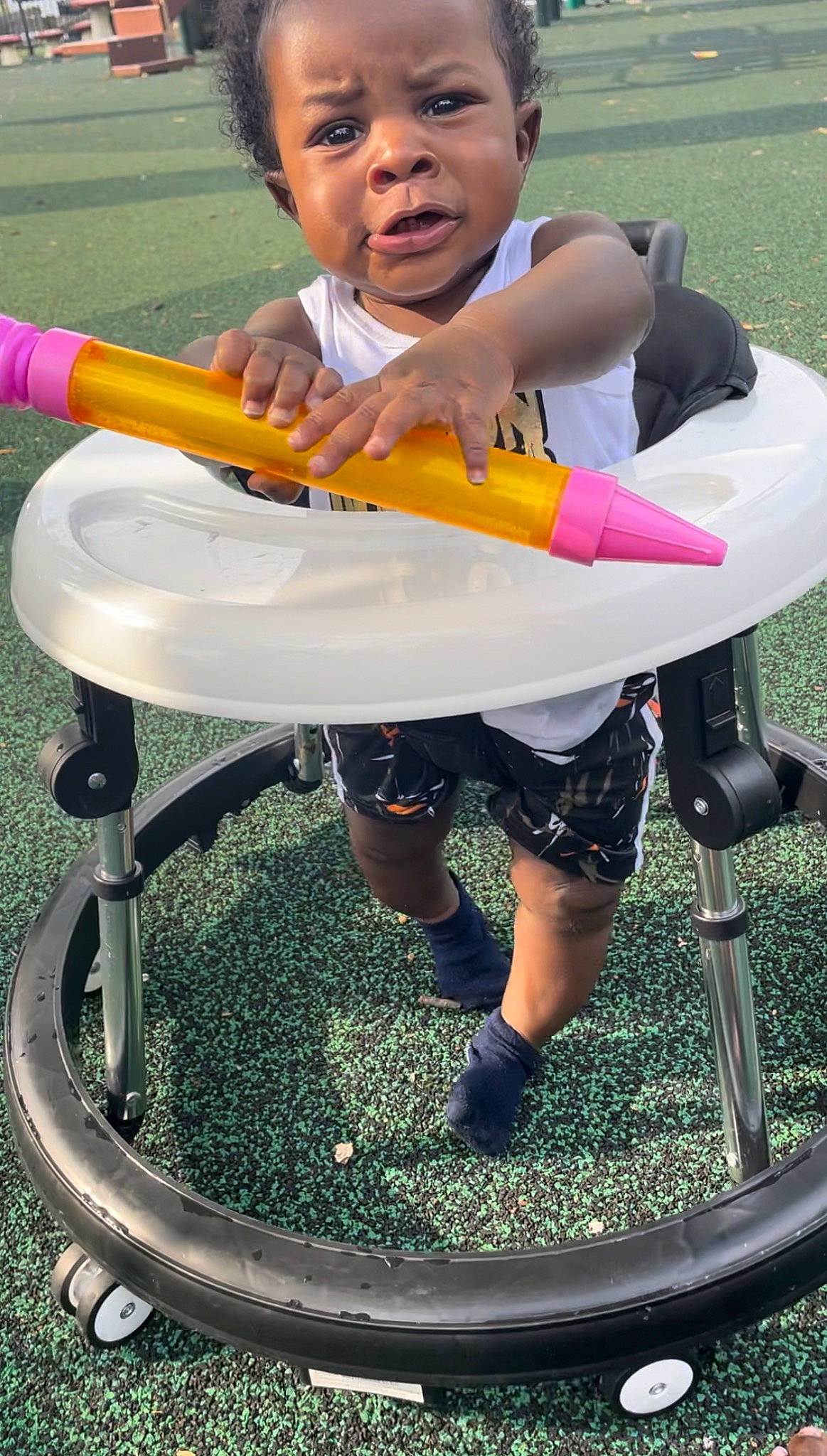 Jrue joined the competition — help win amazing prizes! baby_products, chair, child, fun, grass, green, happy, human_leg, lap, leisure, outdoor_furniture, people_in_nature, person, play, recreation, shorts, sitting, sorrow, t_shirt, thigh