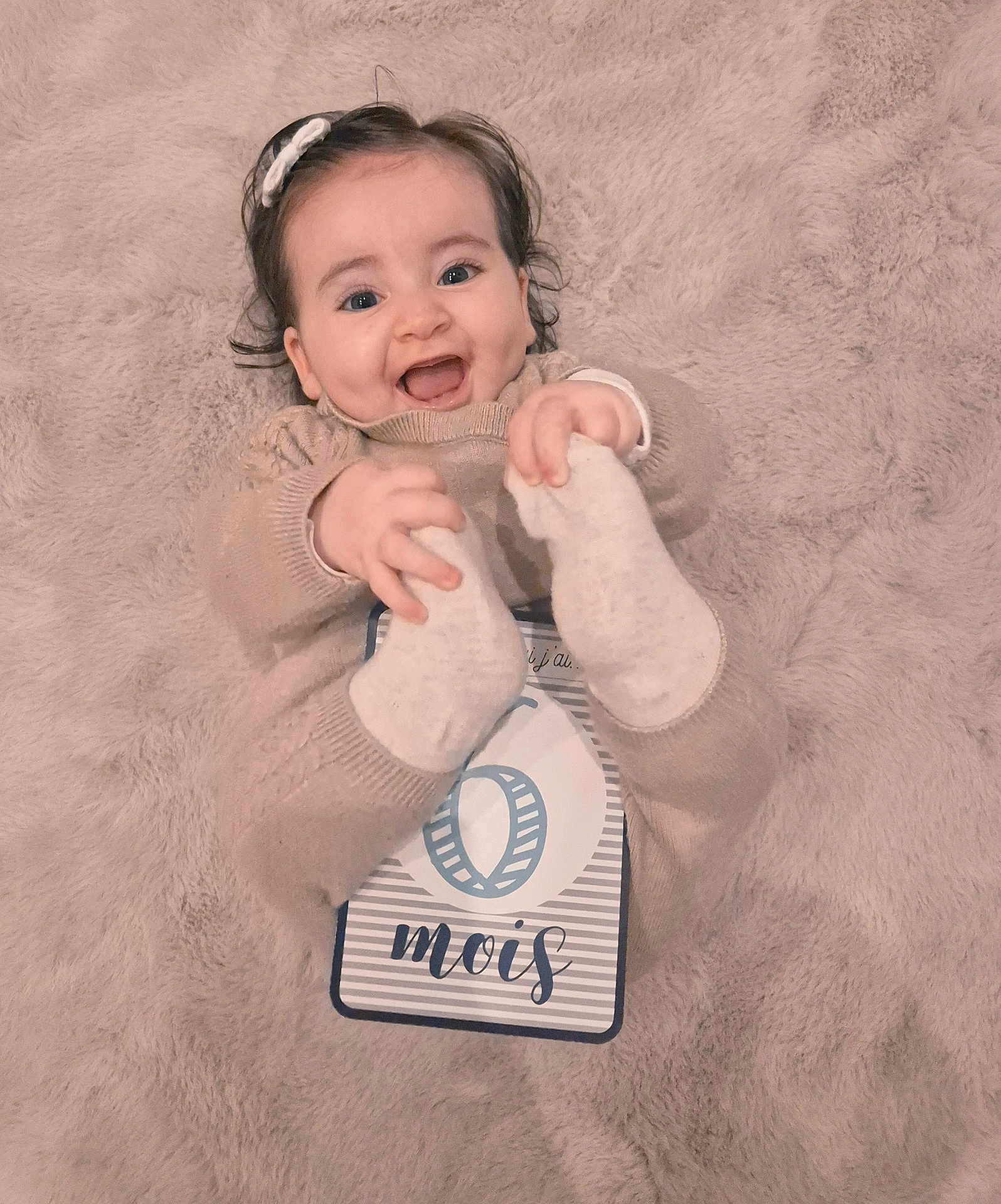 Alba a rejoint le concours — aidez-le/la à gagner de superbes lots ! baby, infant, smile, happy, milestone_card, blanket, soft_texture, cute, clothing, hands, feet, headband, person, portrait, lying_down, cozy, warm, child, celebration, newborn