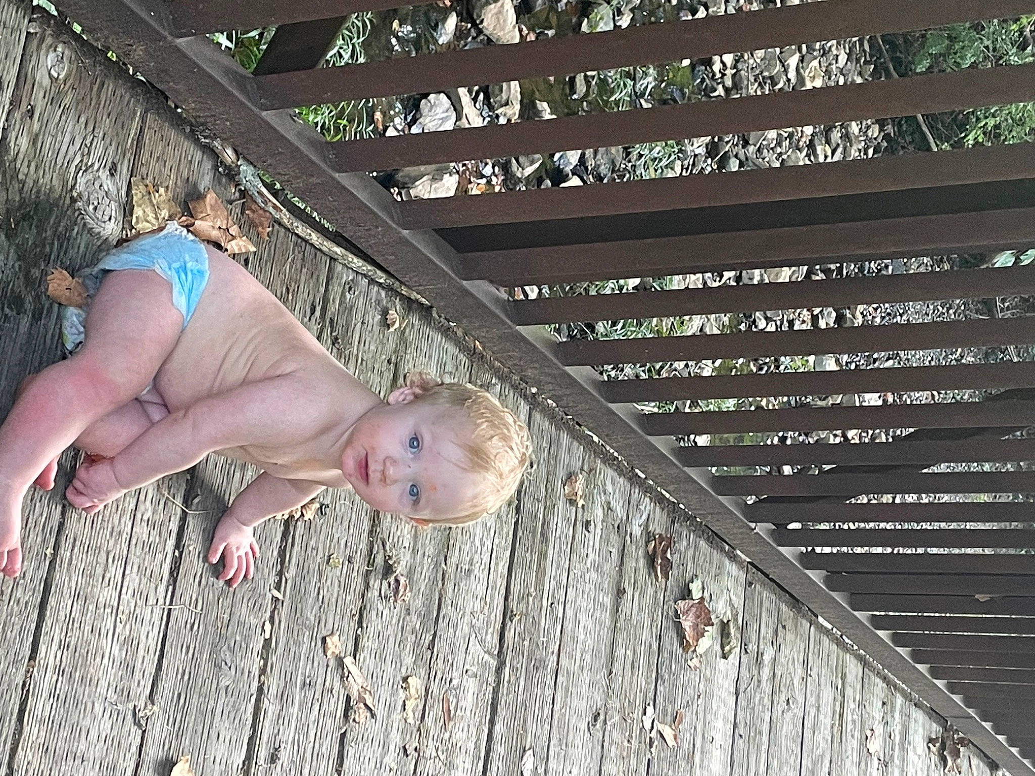 Jaxson is registered to the contest to win money with this photo: baby, baby_toddler_clothing, barefoot, child, flesh, foot, grass, happy, human_leg, pattern, people_in_nature, person, thigh, thumb, toddler, toe, wood