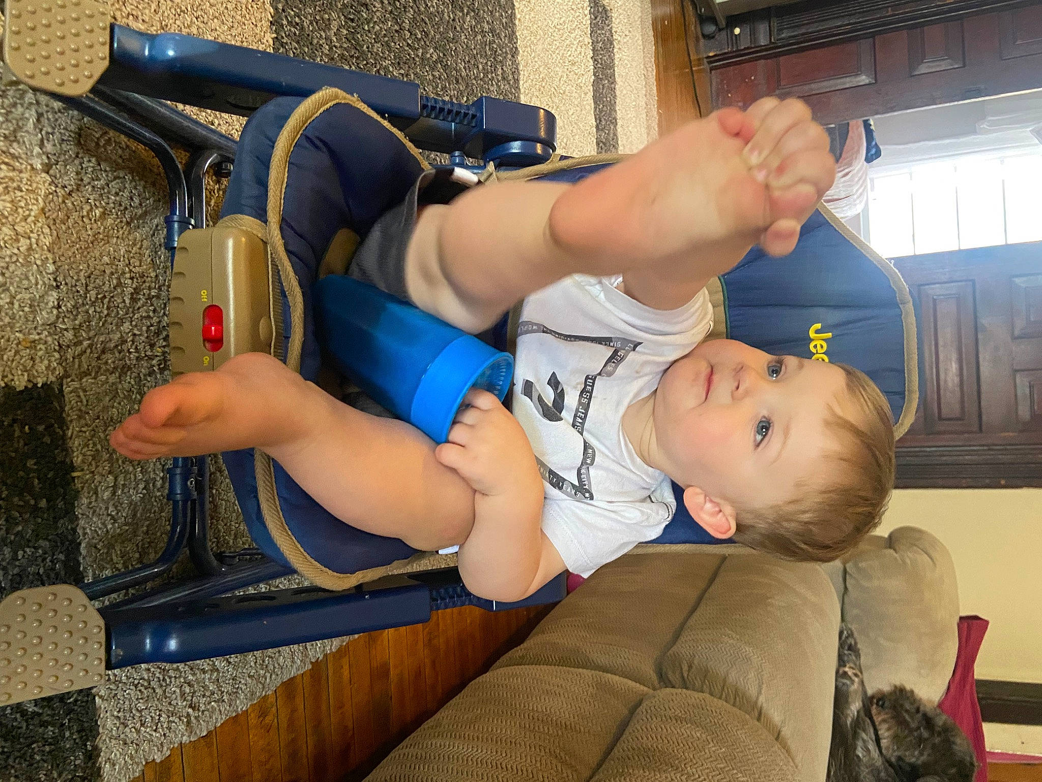 Kamden is registered to the contest to win money with this photo: abdomen, chest, child, comfort, couch, elbow, electric_blue, foot, fun, human_leg, joint, knee, lap, leisure, person, shorts, sitting, sportswear, thigh, toddler