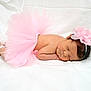 newborn, baby, sleeping, pink_tutu, headband, flower, soft_blanket, infant, cute, peaceful, portrait, resting, skin, lying_down, adorable, small, child, tulle, wearing_accessory, indoors