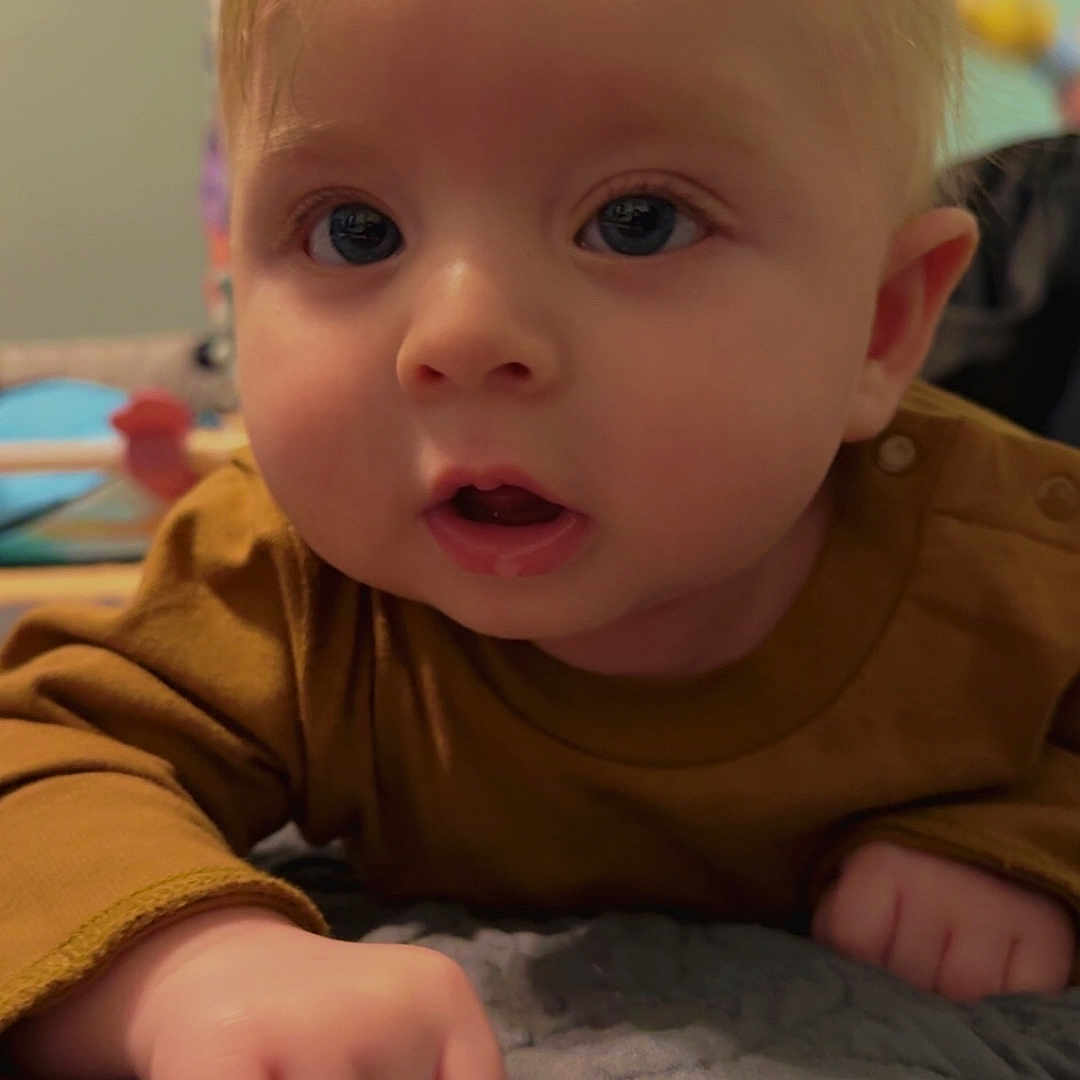 Javier joined the competition — help win amazing prizes! baby, blonde, bodypart, couch, crawling, ear, face, finger, furniture, hair, hand, hardwood, head, mouth, newborn, person, photography, portrait, sitting, wood